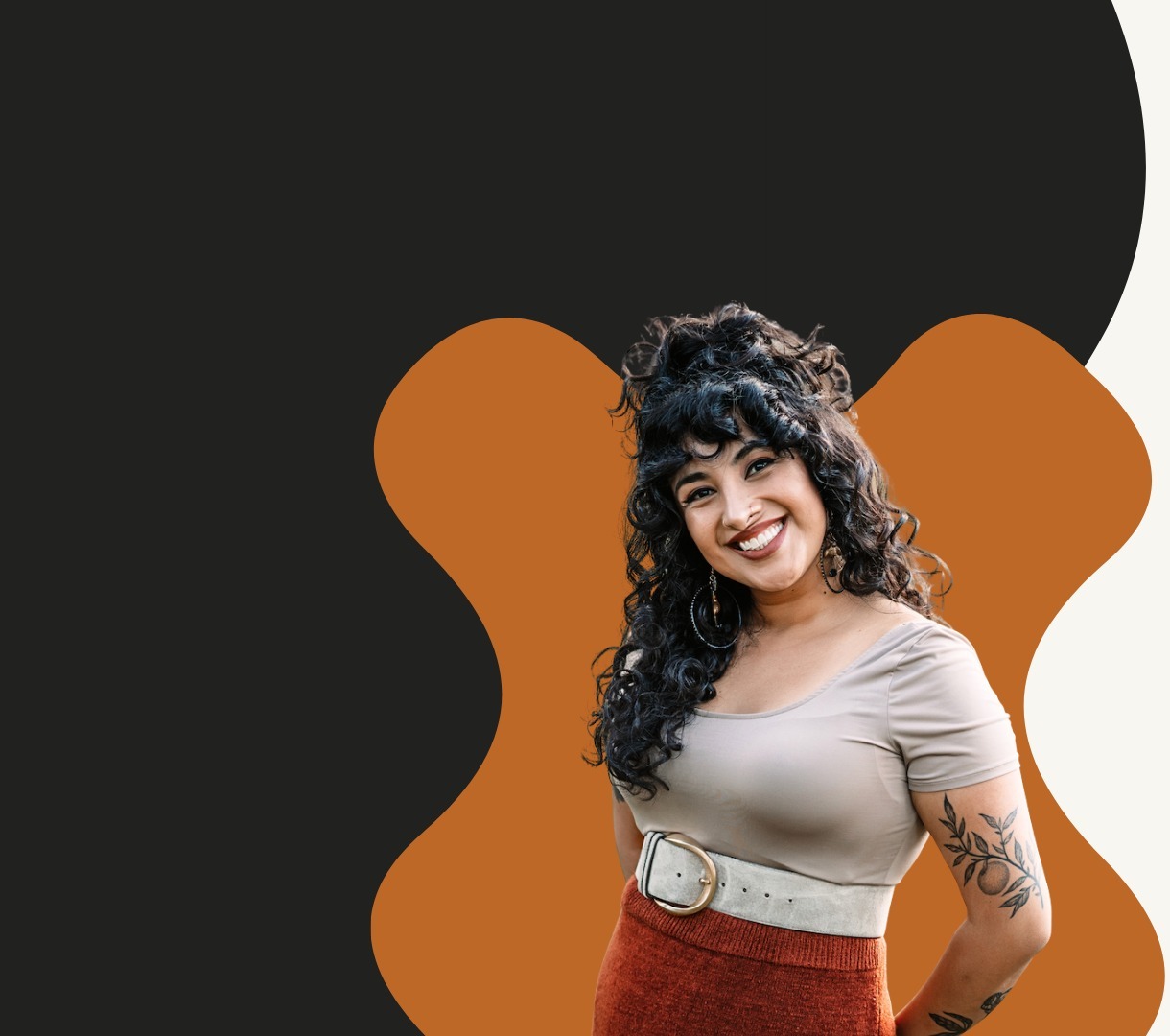 Bren Spector smiling, in front of an orange cut-out shape
