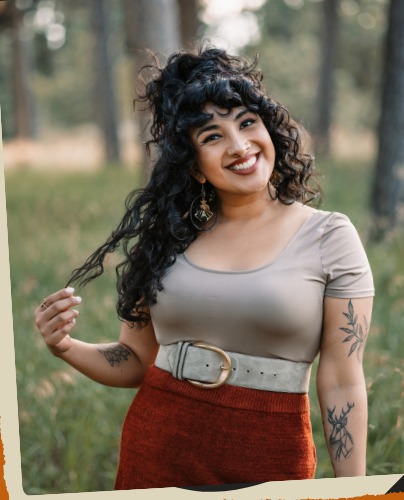 Bren Spector standing in a grassy field, smiling